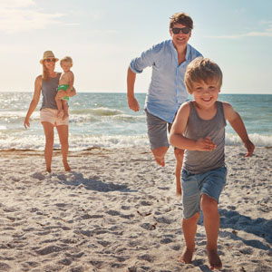 Happy family enjoying time together at the beach – Family Law representation