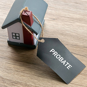 Probate Process Concept with House Model and Legal Tag for Estate Settlement