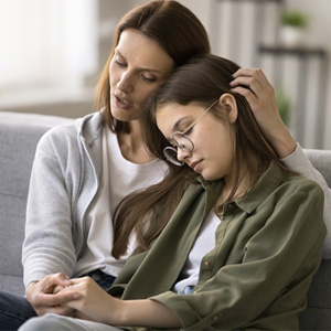 Mother comforting her daughter, illustrating the emotional side of Child Support decisions